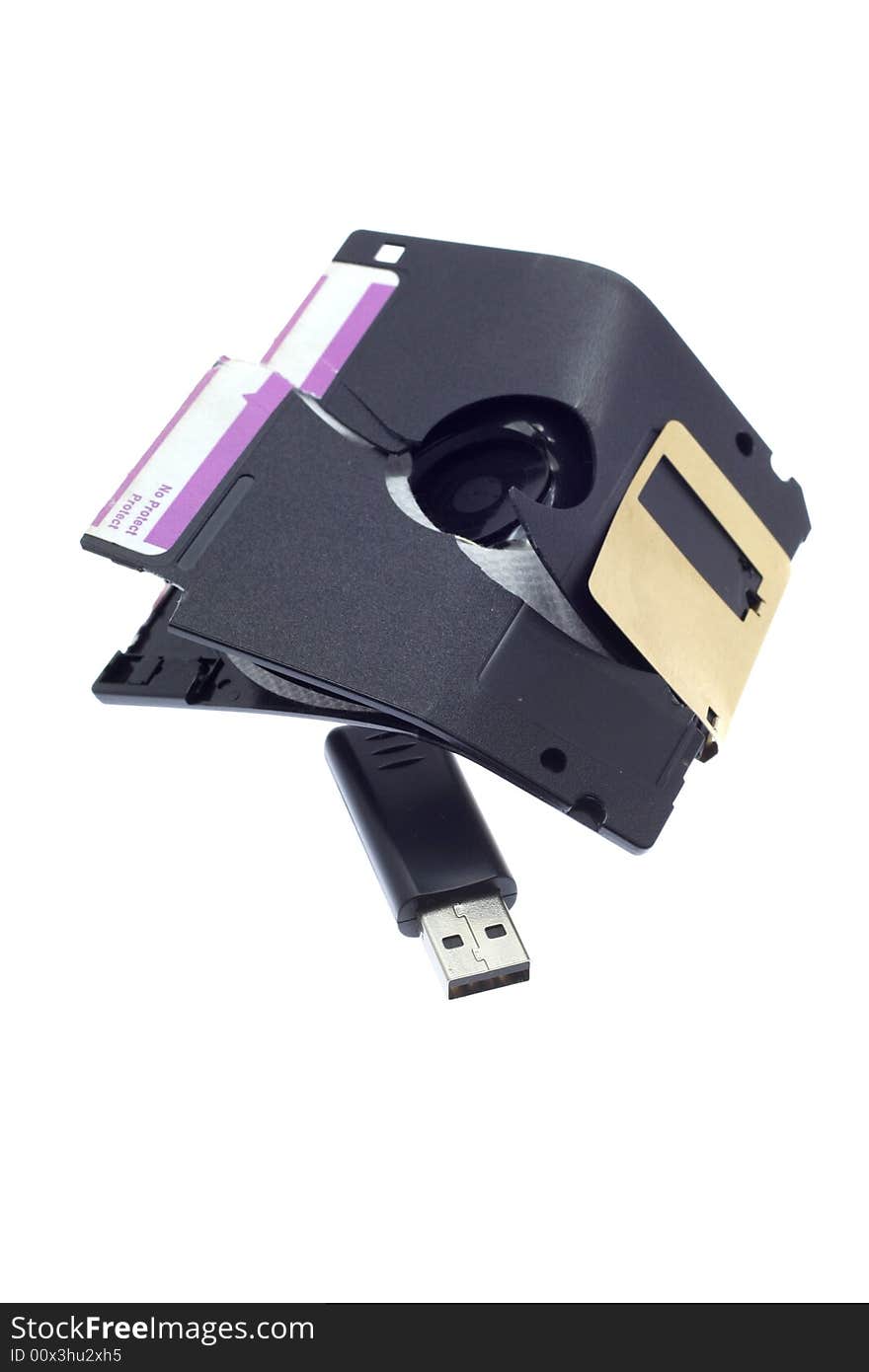 Broken old a diskette and USB flash on a white background. Broken old a diskette and USB flash on a white background