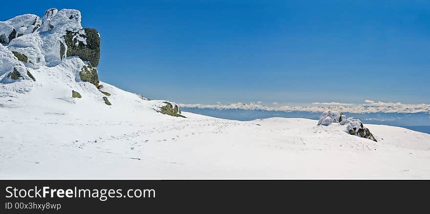 Snowy white mountain slope with blue sky panorama. Snowy white mountain slope with blue sky panorama