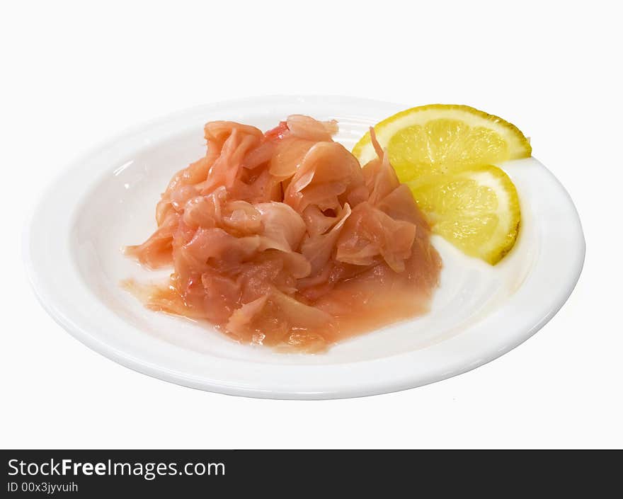 Ginger on the white plate with lemon isolated