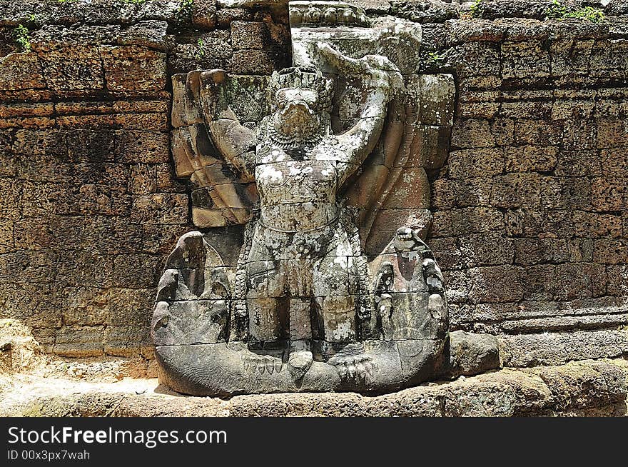 The Preah Khan temple was constructed in the style of bayon in the  late 12th century by the king Jayavarman VII; more than a temple it was probably a Buddhist university; the walls and pilliars are decorated with religious and mythological figures;  in this picture a giant garuda on the east wall. The Preah Khan temple was constructed in the style of bayon in the  late 12th century by the king Jayavarman VII; more than a temple it was probably a Buddhist university; the walls and pilliars are decorated with religious and mythological figures;  in this picture a giant garuda on the east wall