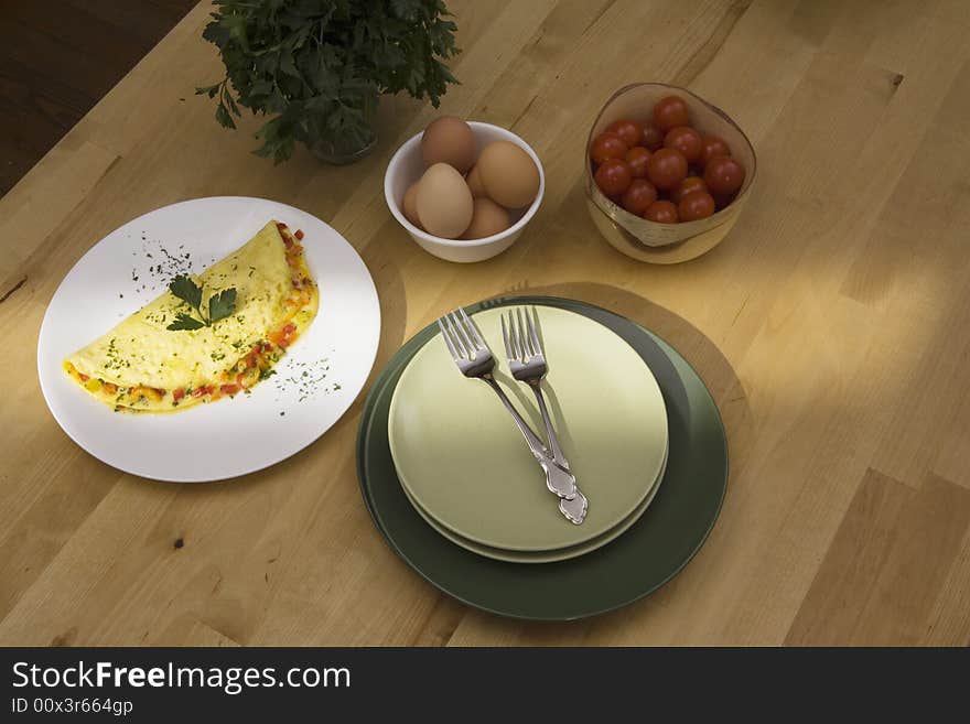 A streak of morning light falls accross a plate of a breakfast omelet. A streak of morning light falls accross a plate of a breakfast omelet.