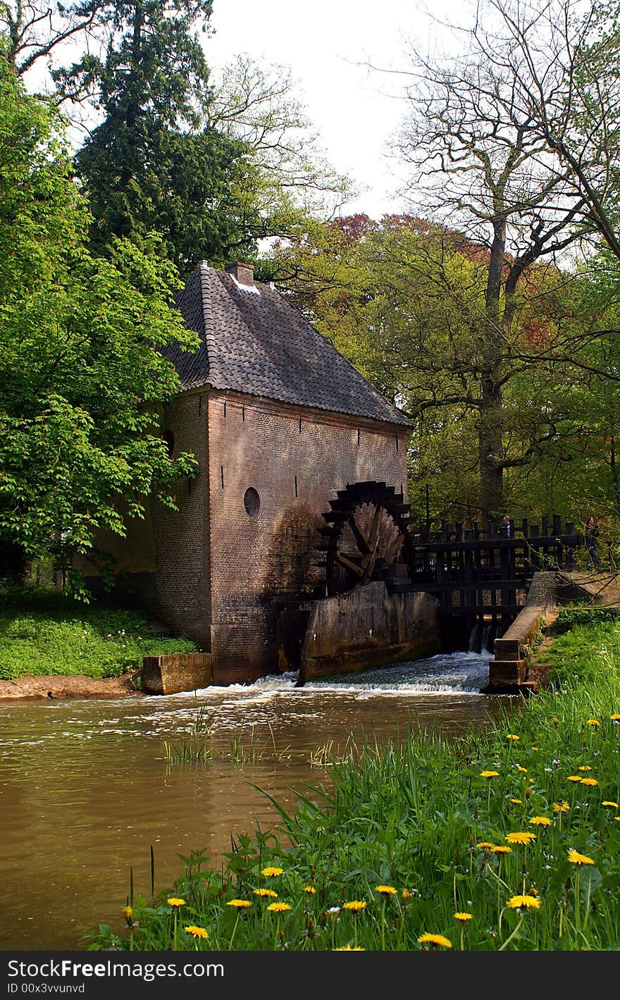 Romantic watermill with trees and flowers in spring. Romantic watermill with trees and flowers in spring