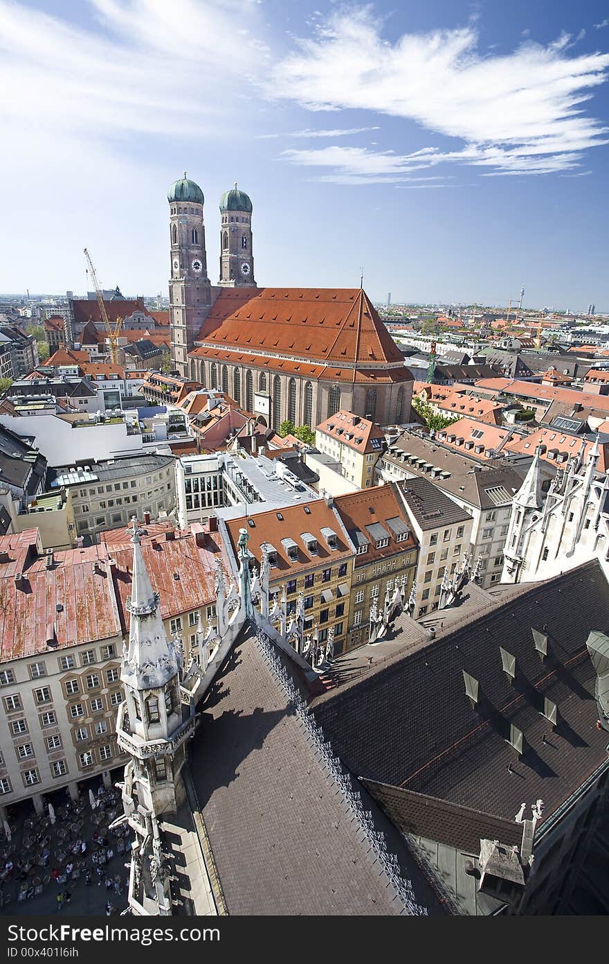 Munich's skyline featuring the Frauenkirche and local street cafes. Munich's skyline featuring the Frauenkirche and local street cafes