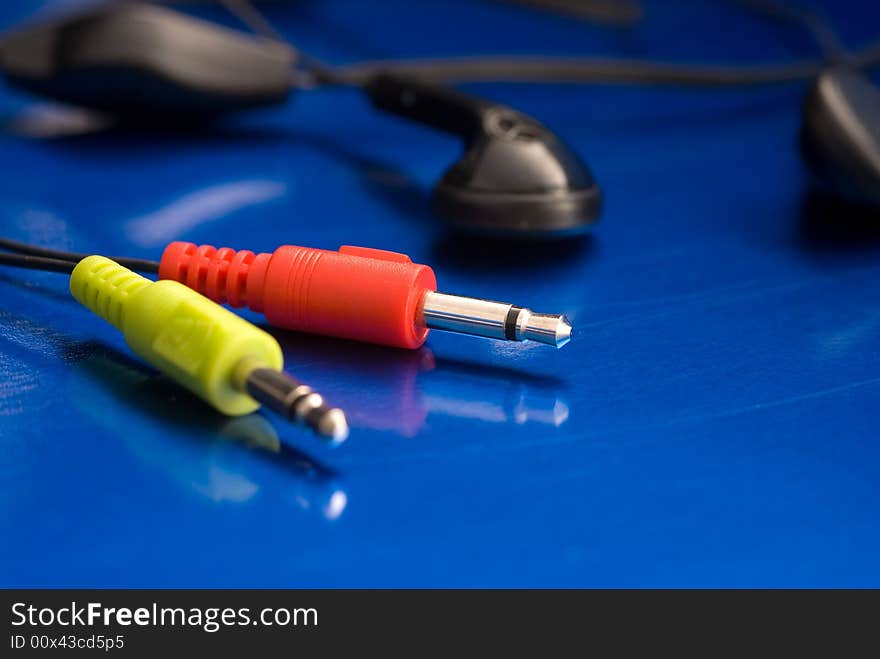 Headphone plugs isolated on a blue background