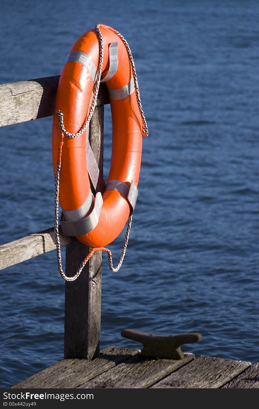 Red lifebelt at the sea. Red lifebelt at the sea