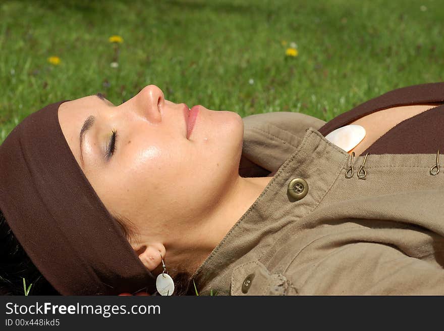 Attractive woman relaxing on green grass. Attractive woman relaxing on green grass