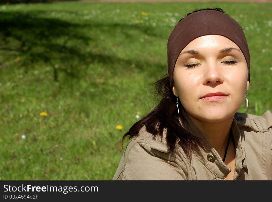 Attractive woman relaxing on green grass. Attractive woman relaxing on green grass