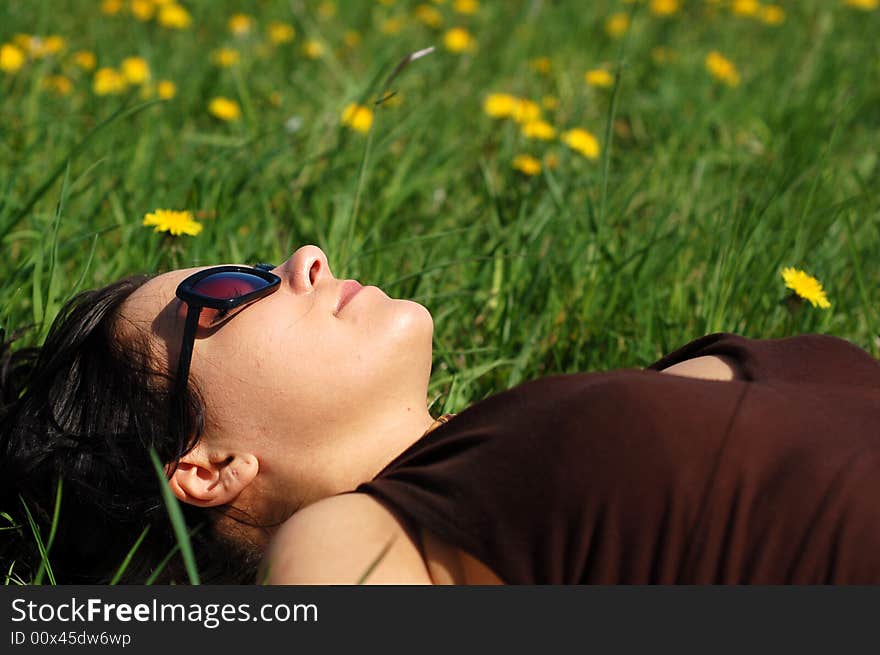 Attractive woman relaxing on green grass. Attractive woman relaxing on green grass