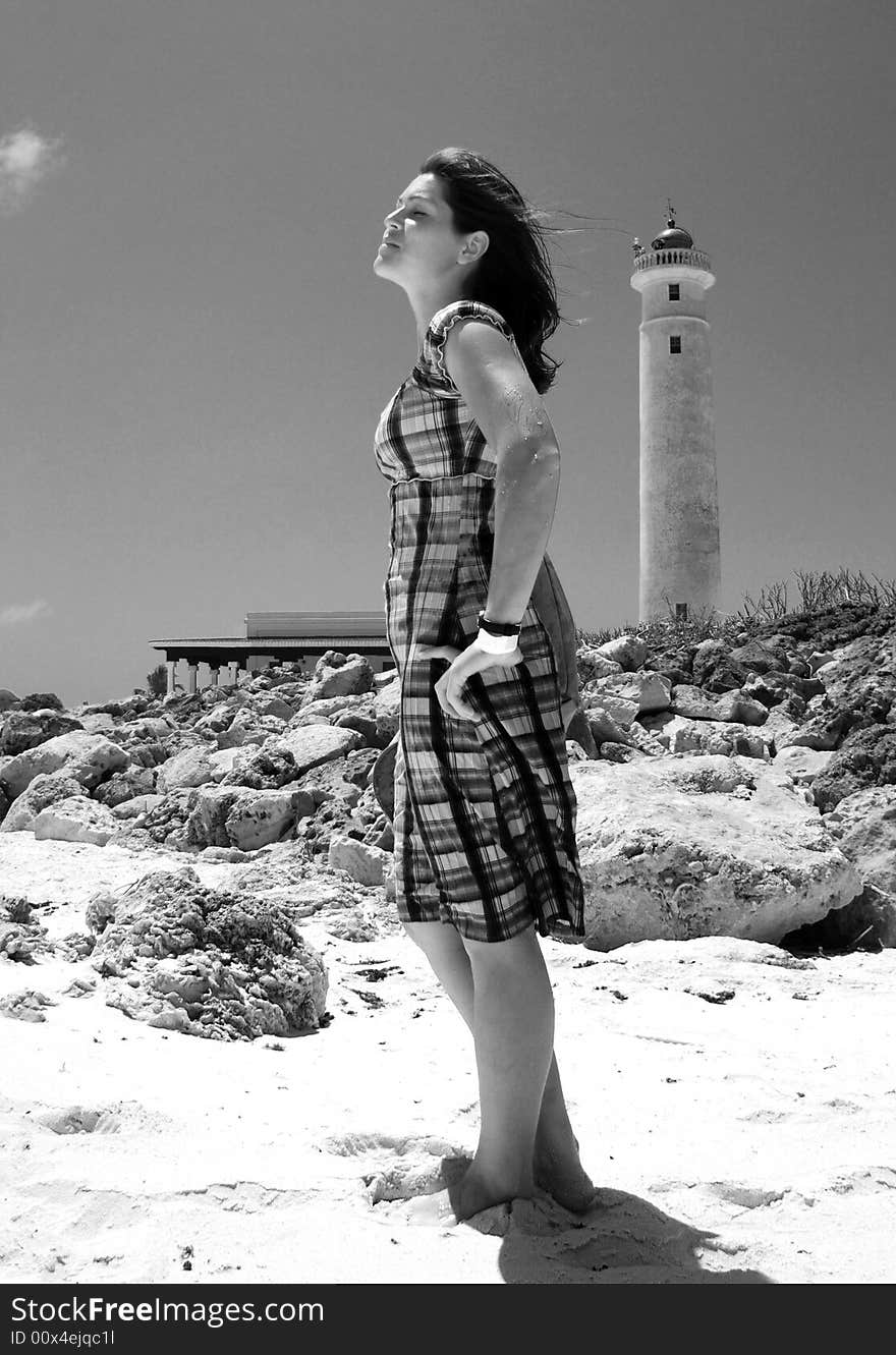 The girl standing by the lighthouse in Punta Sur Eco Park on Cozumel island, Mexico.