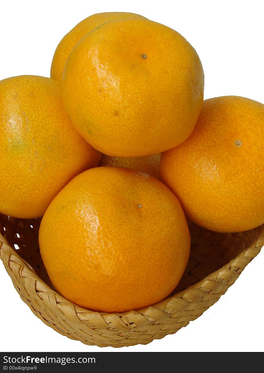 The large ripe juicy oranges with a yellow leather(skin) lay in a straw plate. The large ripe juicy oranges with a yellow leather(skin) lay in a straw plate