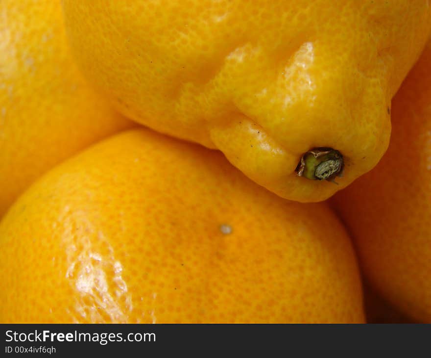 The large ripe juicy oranges with a yellow leather(skin) lay in a straw plate. The large ripe juicy oranges with a yellow leather(skin) lay in a straw plate