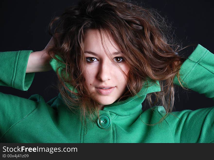 Beauty fashion woman in green clothes at black background. Beauty fashion woman in green clothes at black background