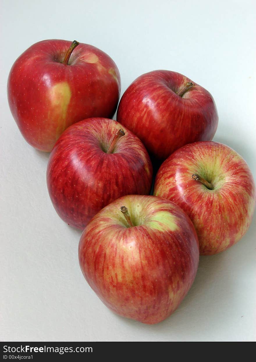 The large ripe juicy red apples lay on a table. The large ripe juicy red apples lay on a table