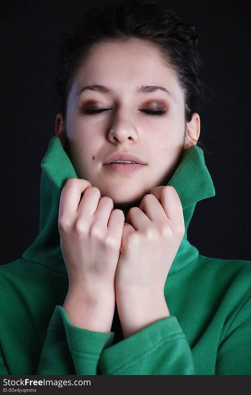 Beauty fashion woman in green clothes at black background. Beauty fashion woman in green clothes at black background