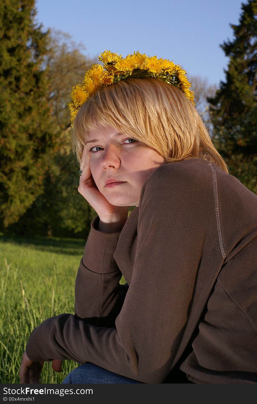 Worried blond hair woman in dandelions garland. Worried blond hair woman in dandelions garland