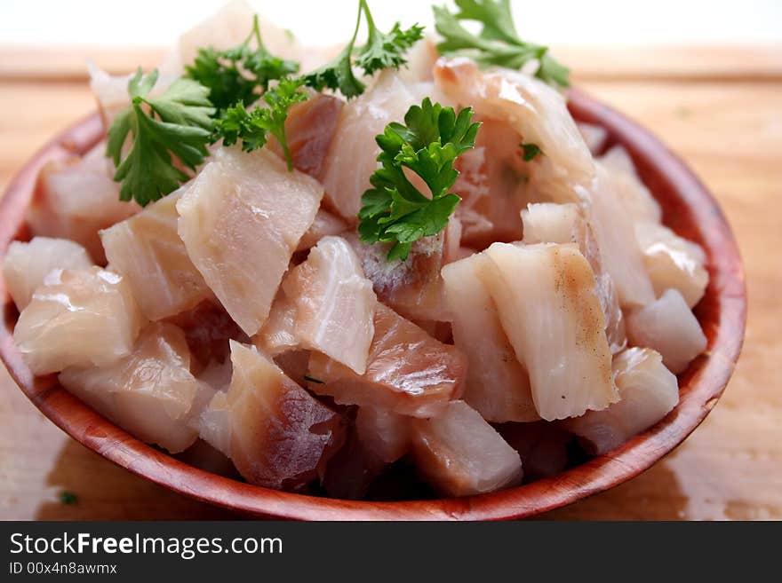 A bowl with fresh fish and some spices