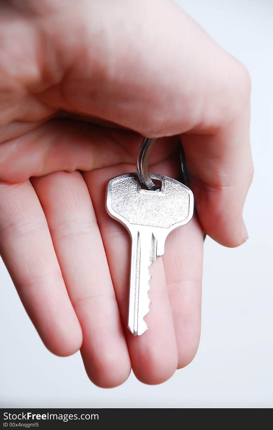 Key from house in hand at white background. Key from house in hand at white background