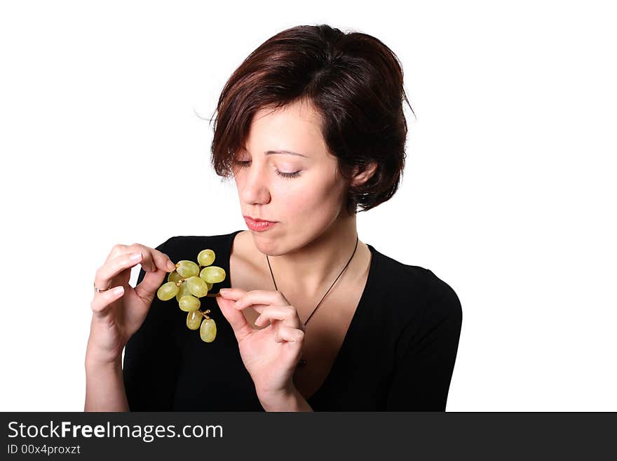 Girl sceptically looking on grape