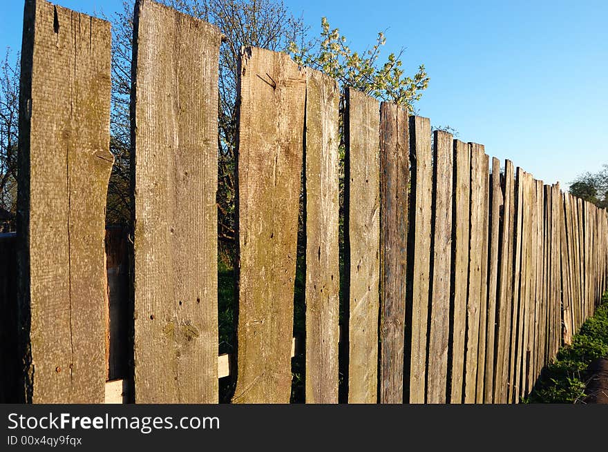 Old wooden fence over a blue sky