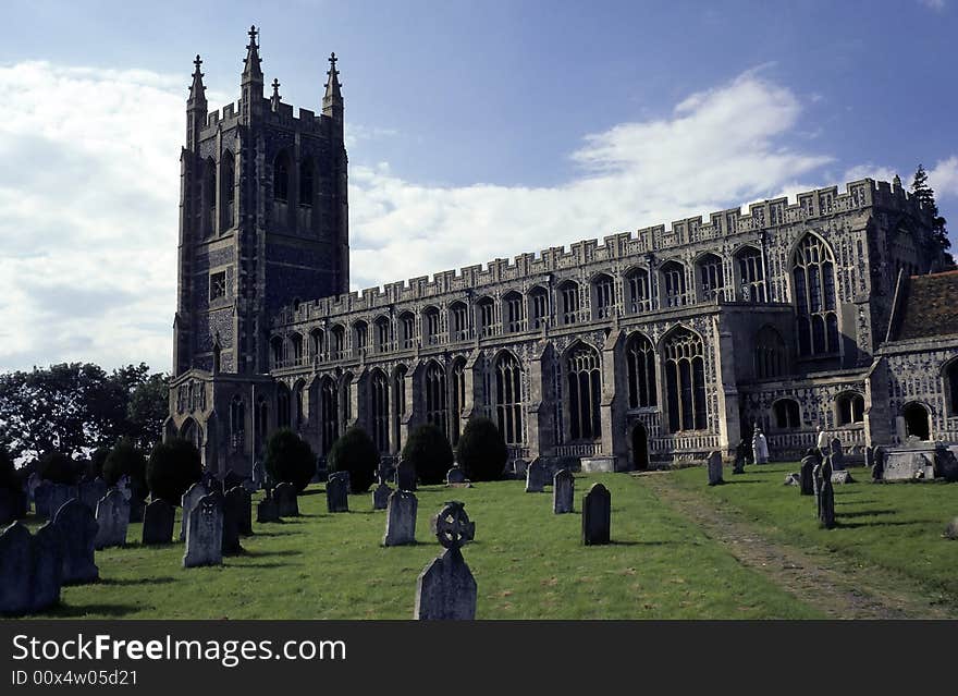 Cathedral like ancient english church and graveyard on sunny day. Cathedral like ancient english church and graveyard on sunny day