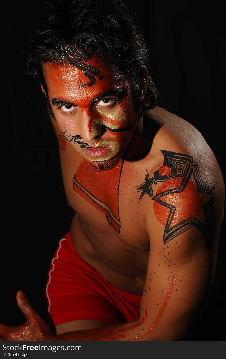 Portrait of young hispanic male model wearing artistic bodypaint drawing. Portrait of young hispanic male model wearing artistic bodypaint drawing