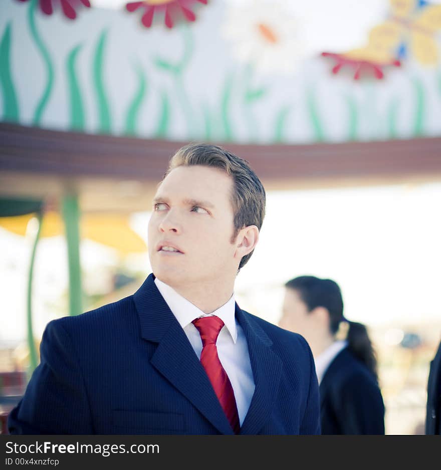 Business people standing wearing suits with one businessman looking away with worried look