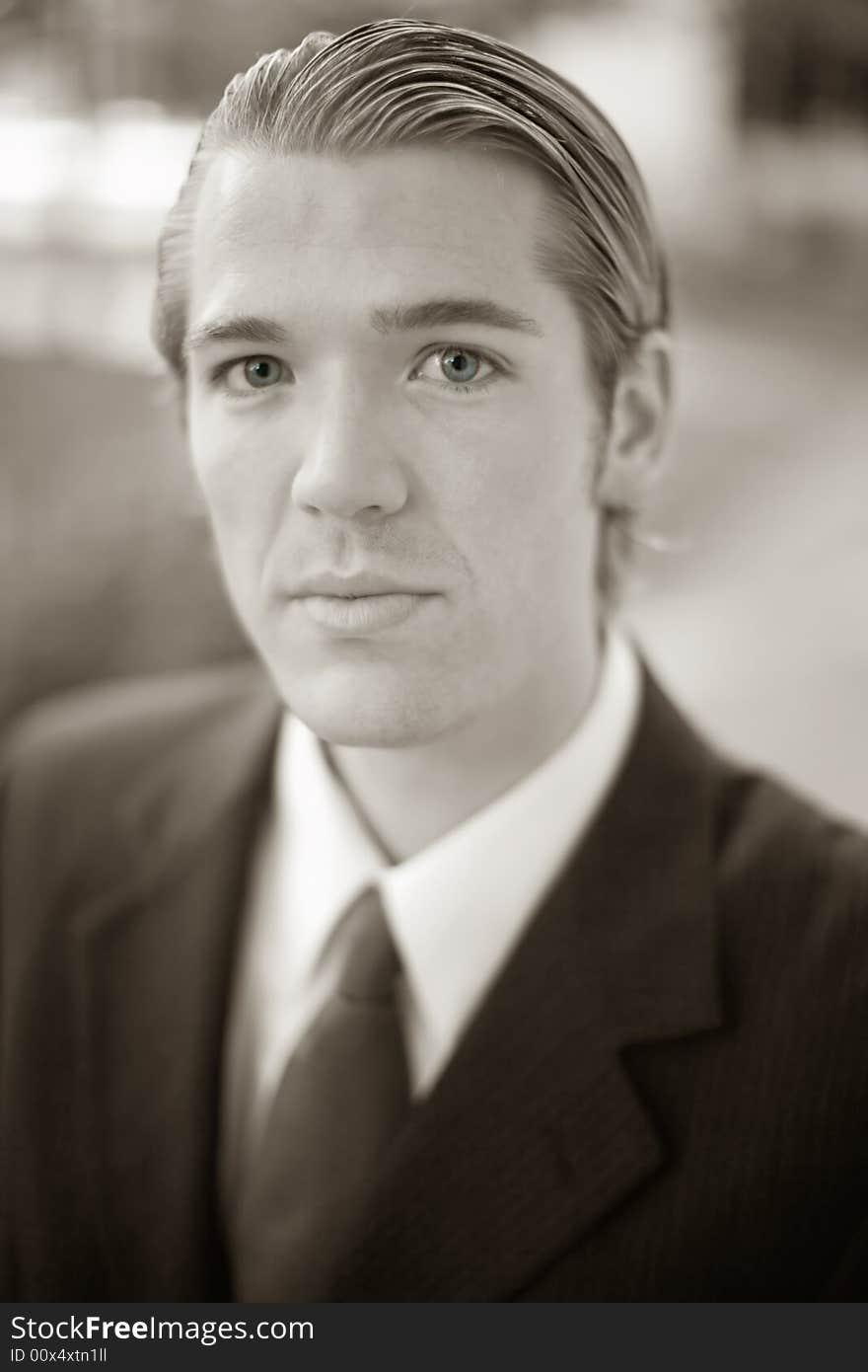 Close-up portrait of handsome businessman dressed in full suit and tie