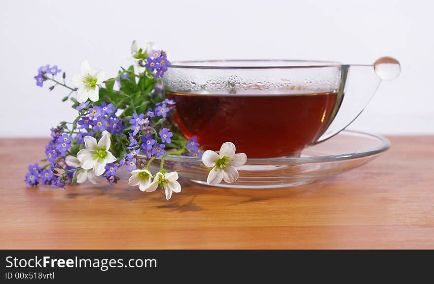 Black tea in a cup and flowers