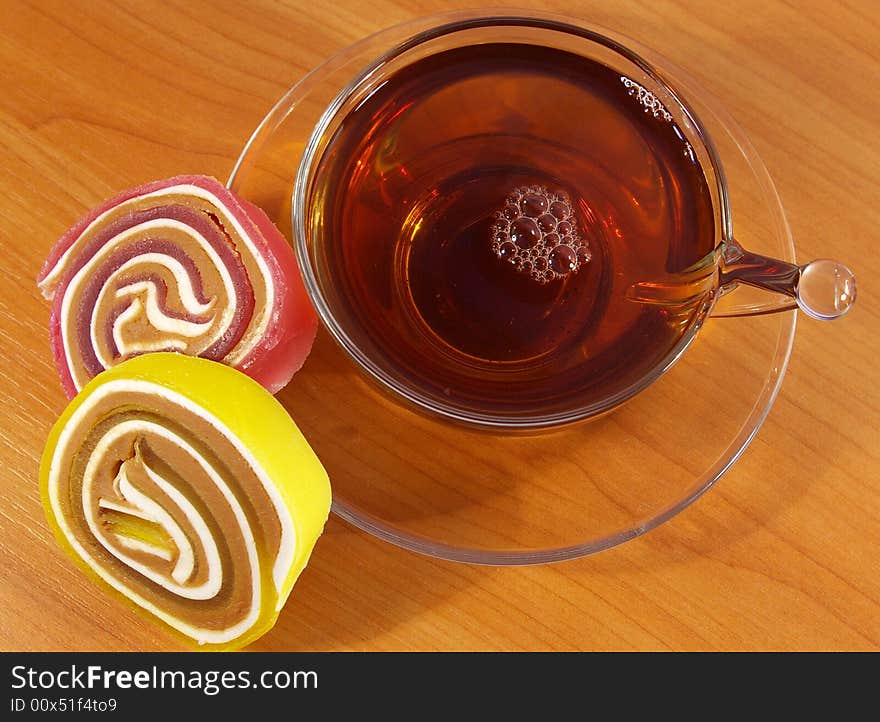 Colorful fruit candy and cup of tea. Colorful fruit candy and cup of tea