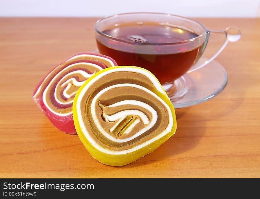 Colorful fruit candy and cup of tea. Colorful fruit candy and cup of tea