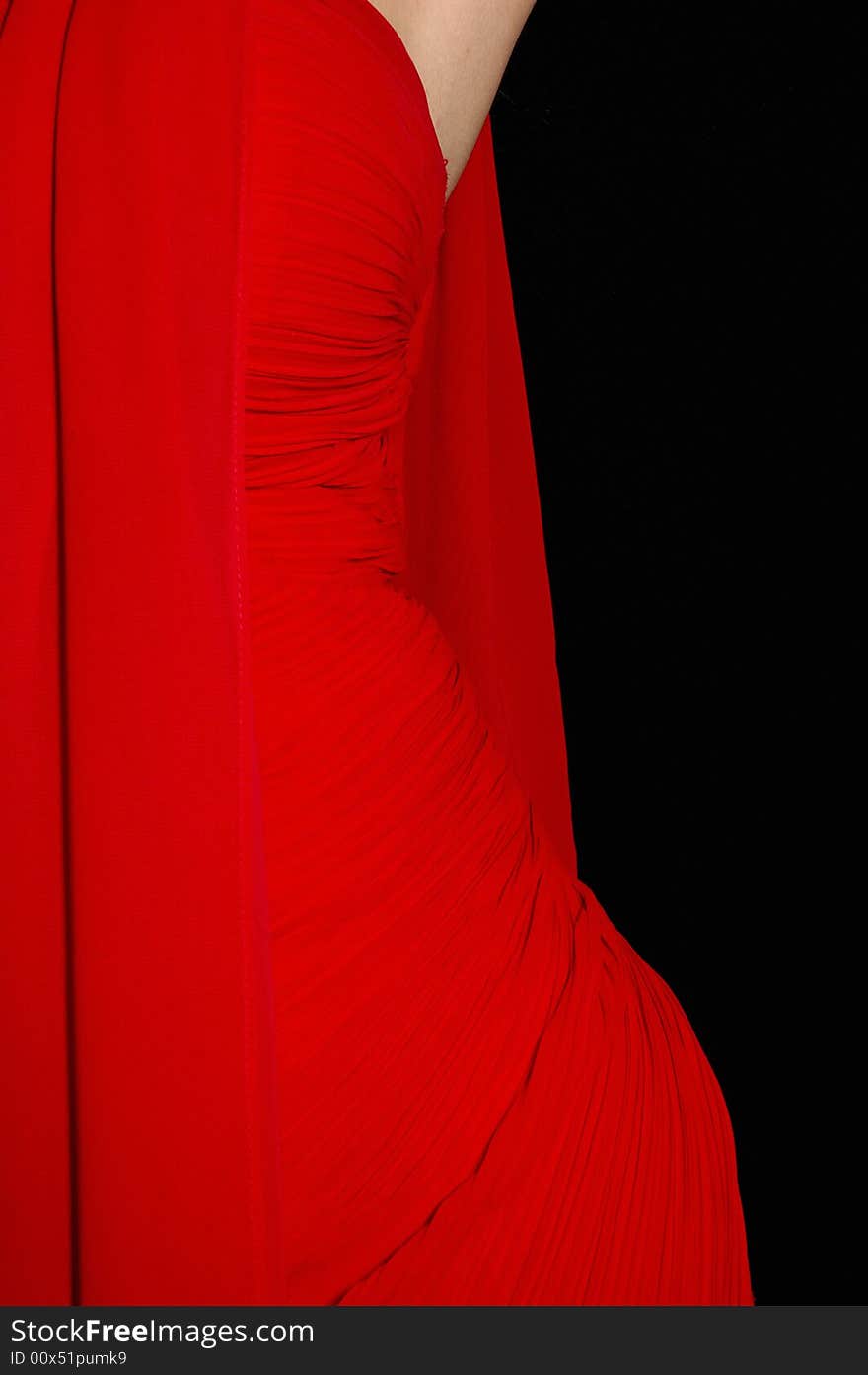 Attractive blond model with red gown on the black background. Attractive blond model with red gown on the black background