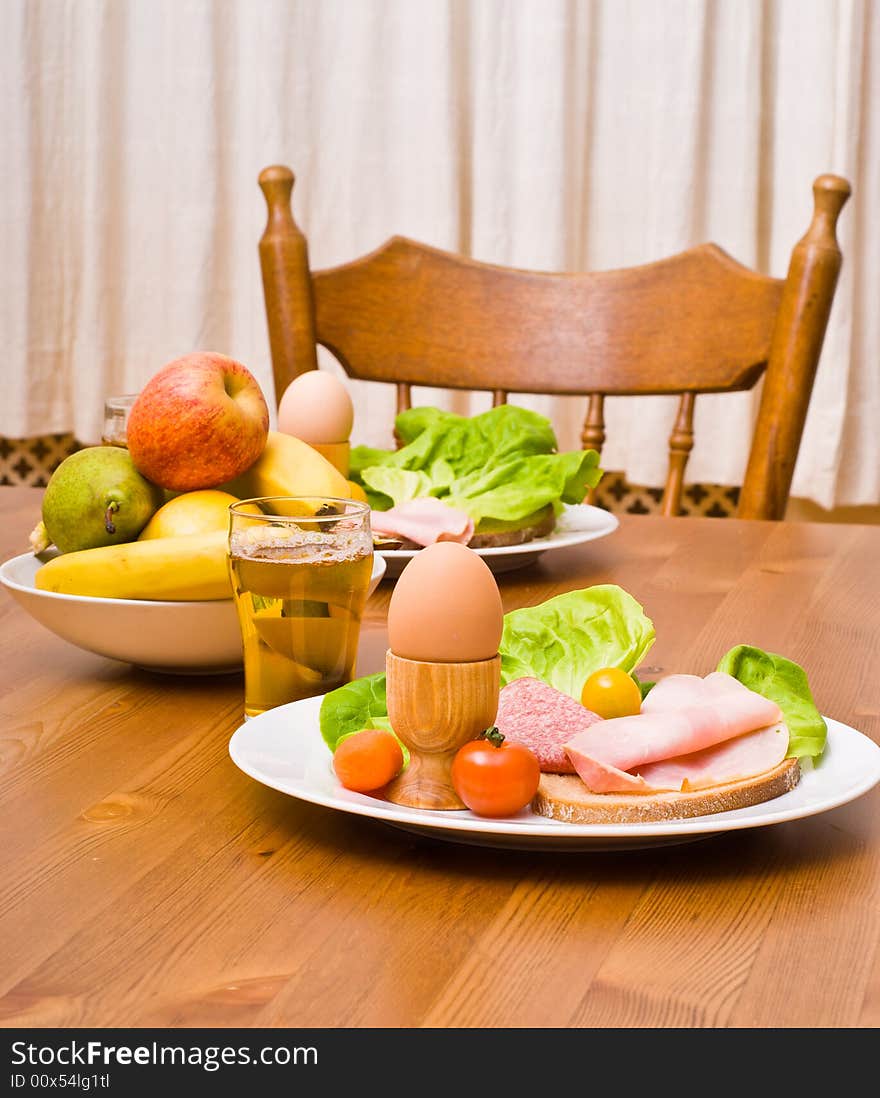 Table served with snacks. Fruits, vegetables, bread, egg, ham etc. Table served with snacks. Fruits, vegetables, bread, egg, ham etc.