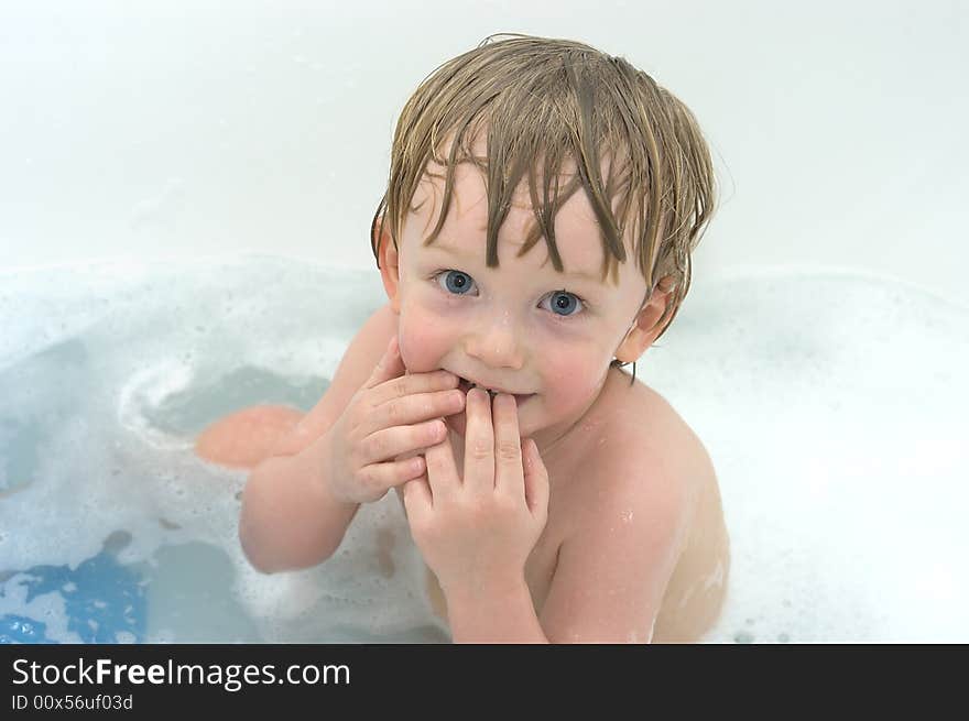 Cheerful boy on white background. In bath. Cheerful boy on white background. In bath.