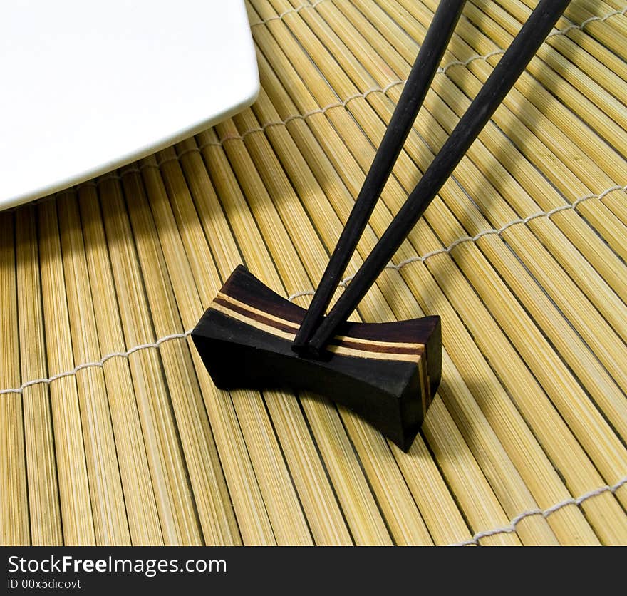 Chopsticks and bamboo mat close up