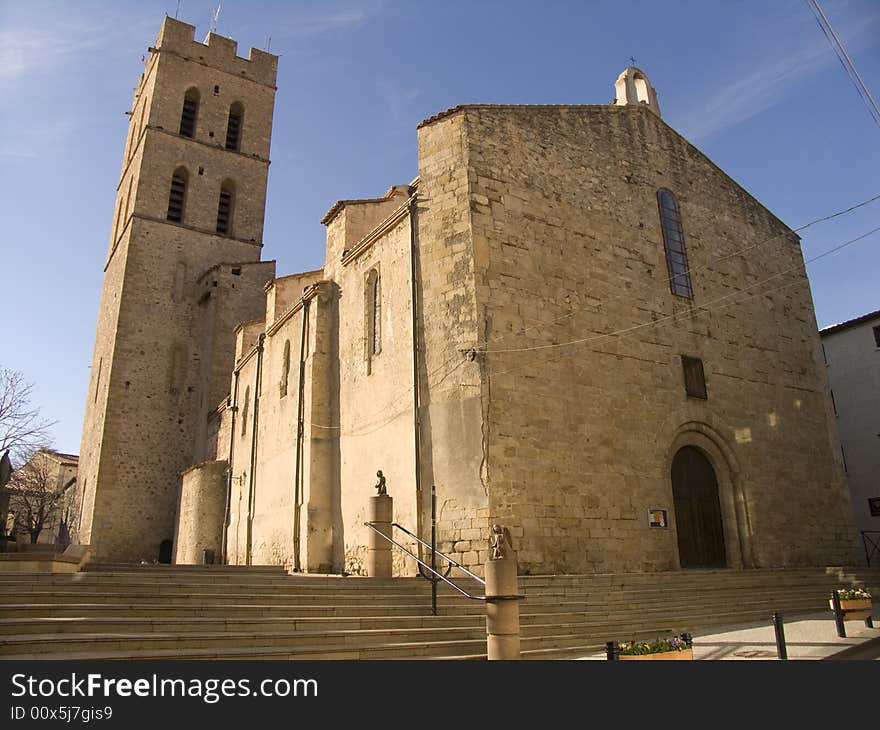 The bell tower and a French church, in the late afternoon.