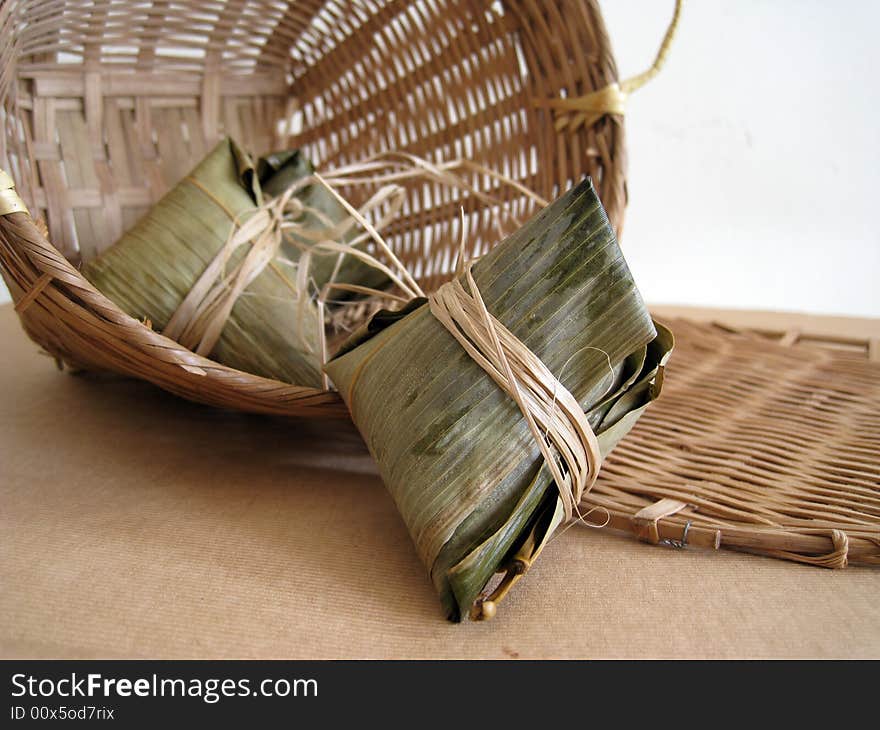 A pyramid-shaped mass of glutinous rice wrapped in leaves, one culture occasion in Chinese