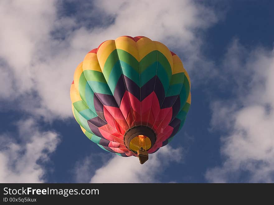 A brightly colored hot air balloon shot from below