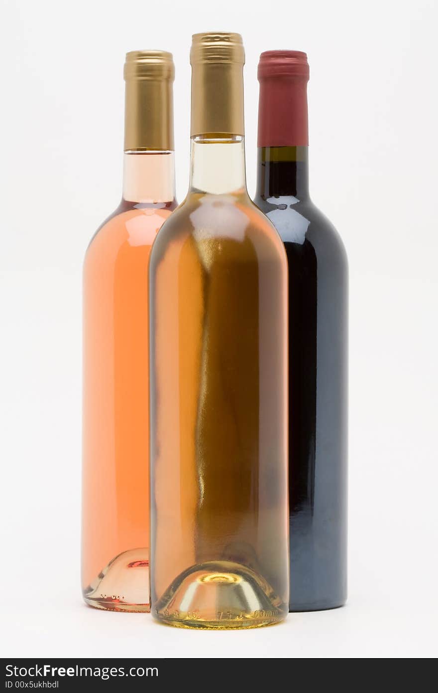 Red white and rose wine bottles on a white background