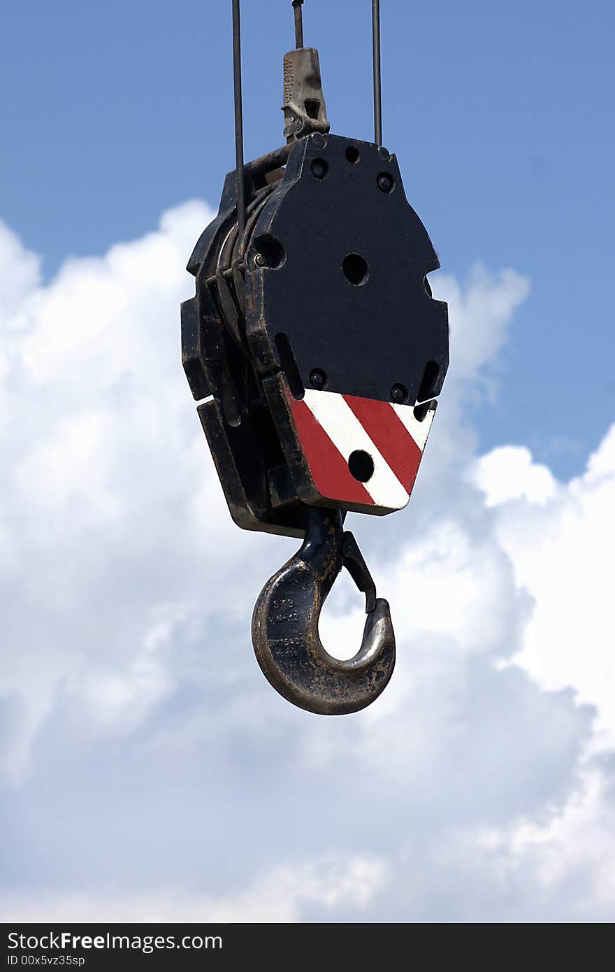 Crane hook and line against cloudy sky. Crane hook and line against cloudy sky