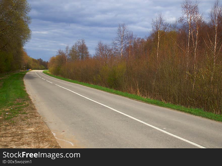 Empty local road on overcast spring day