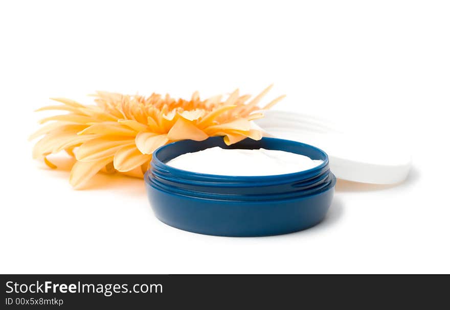 Moisturizing cream with orange gerbera close up