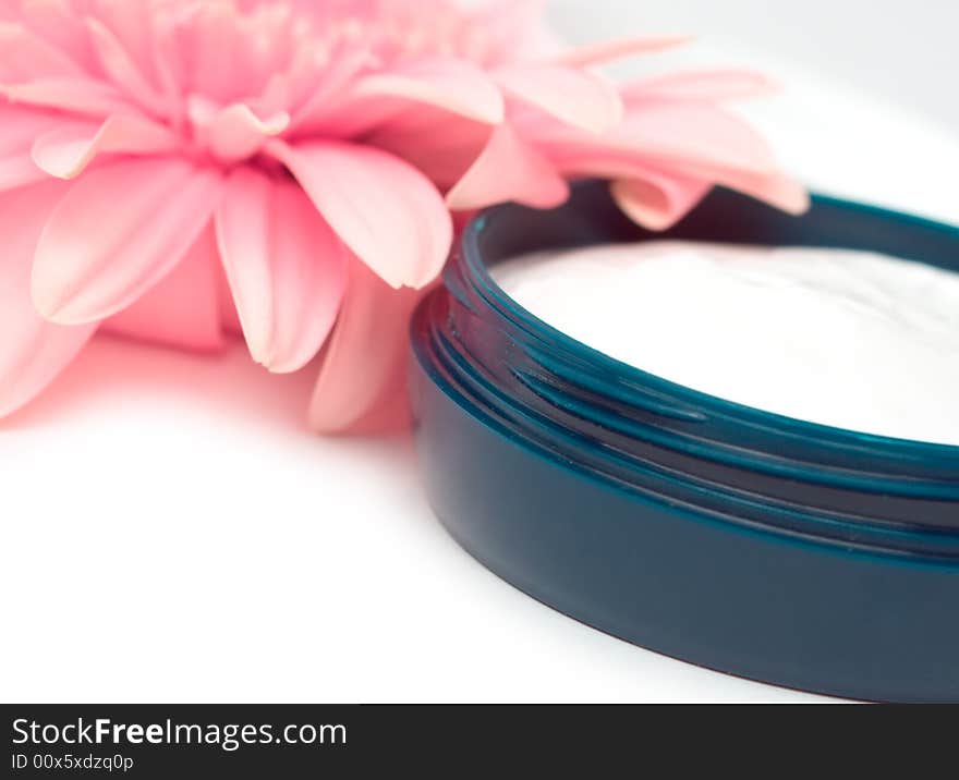 Moisturizing cream with pink gerbera close up