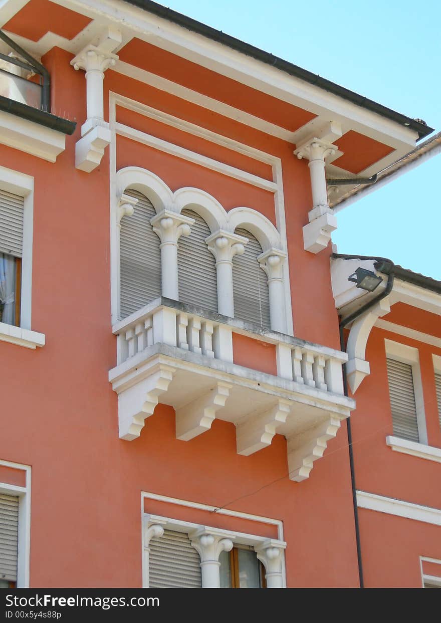 A beautiful window with balcony on a upper class house in Italy