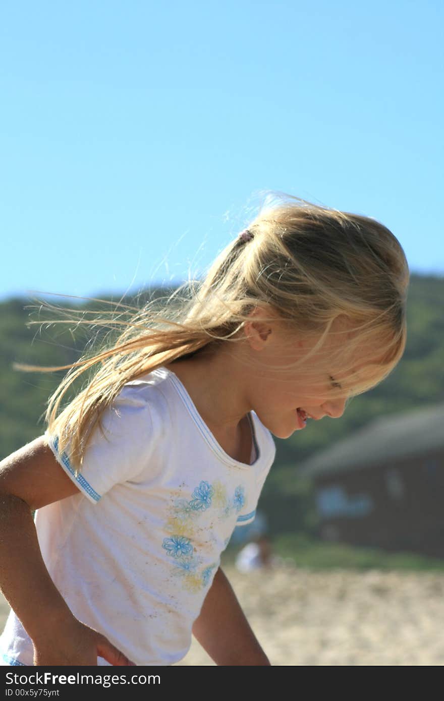 A beautiful white caucasian girl child enjoying the beach. A beautiful white caucasian girl child enjoying the beach