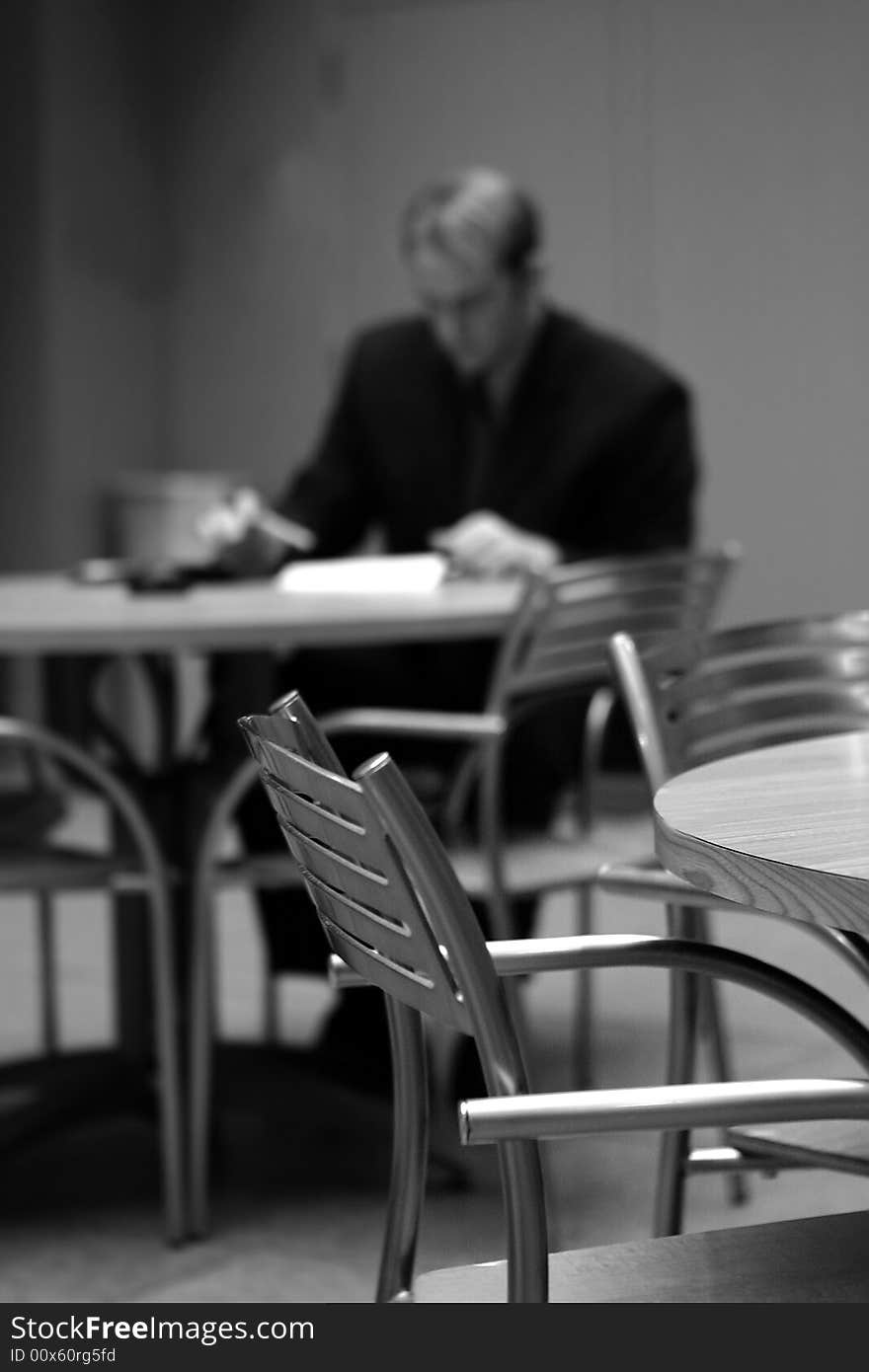 Businessman sitting down at table crunching the numbers. Businessman sitting down at table crunching the numbers