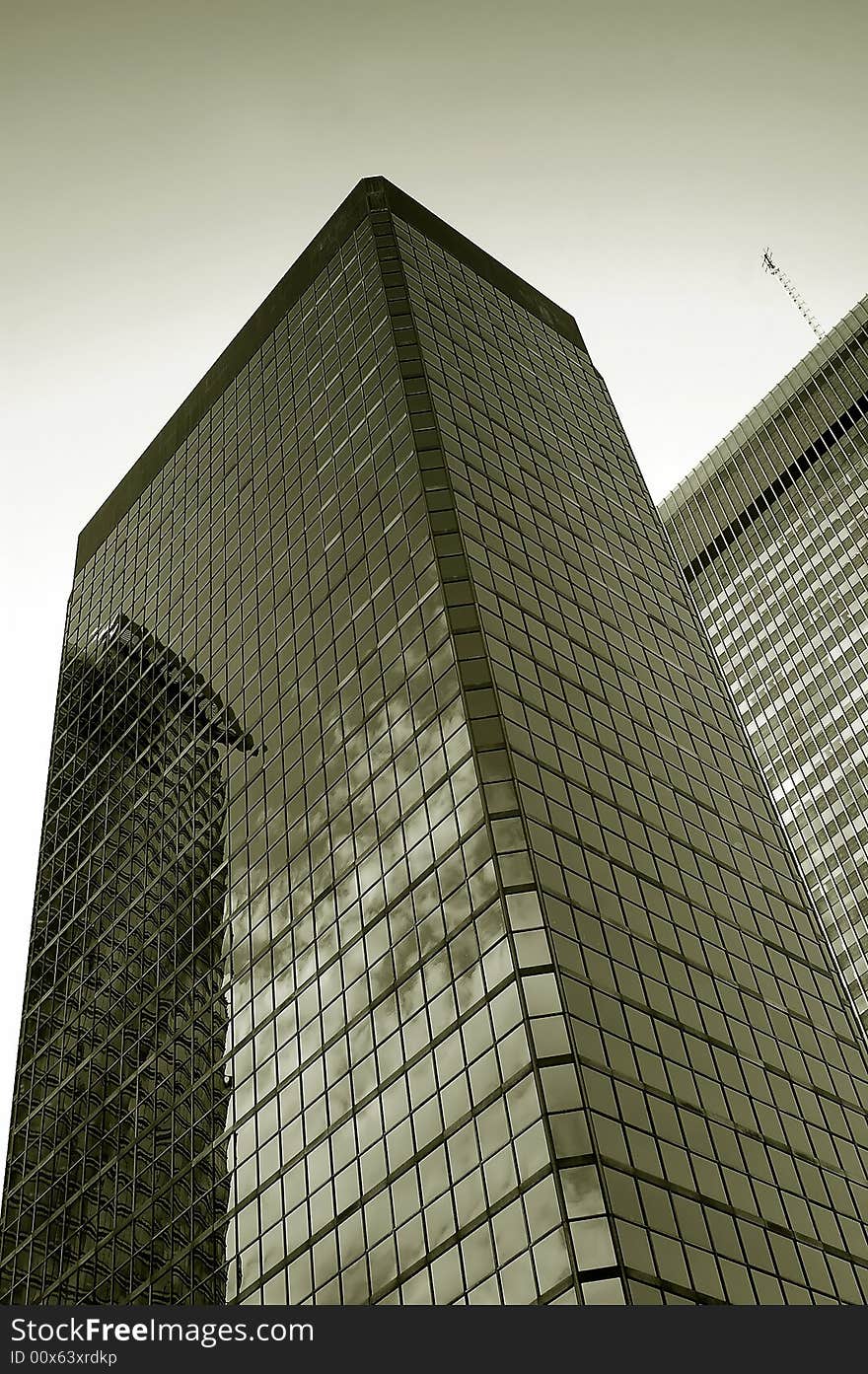 Monochrome image of a tall, modern office building. Monochrome image of a tall, modern office building.