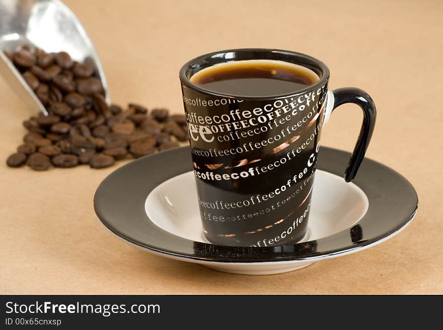 A cup of coffe and coffee beans in the background. A cup of coffe and coffee beans in the background