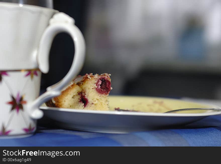 Photo of tea cup and piece of cake on plate