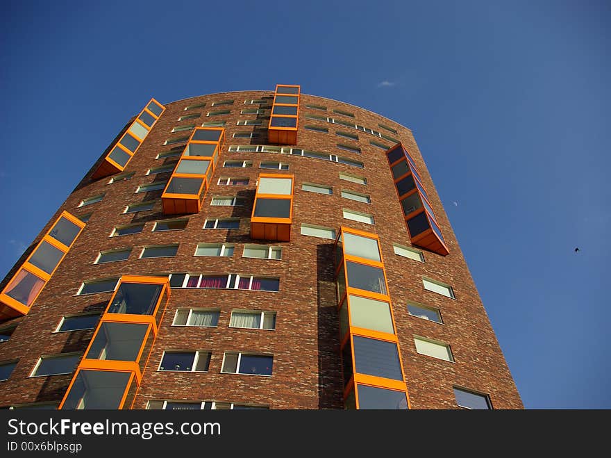 A 21 story building against blue sky. A 21 story building against blue sky.