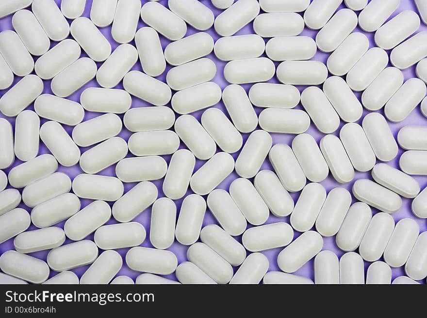 Many white pills as an abstract background